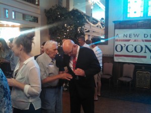 Fran O'Connell speaks with an attendee at his event Monday night. (WMassP&I)